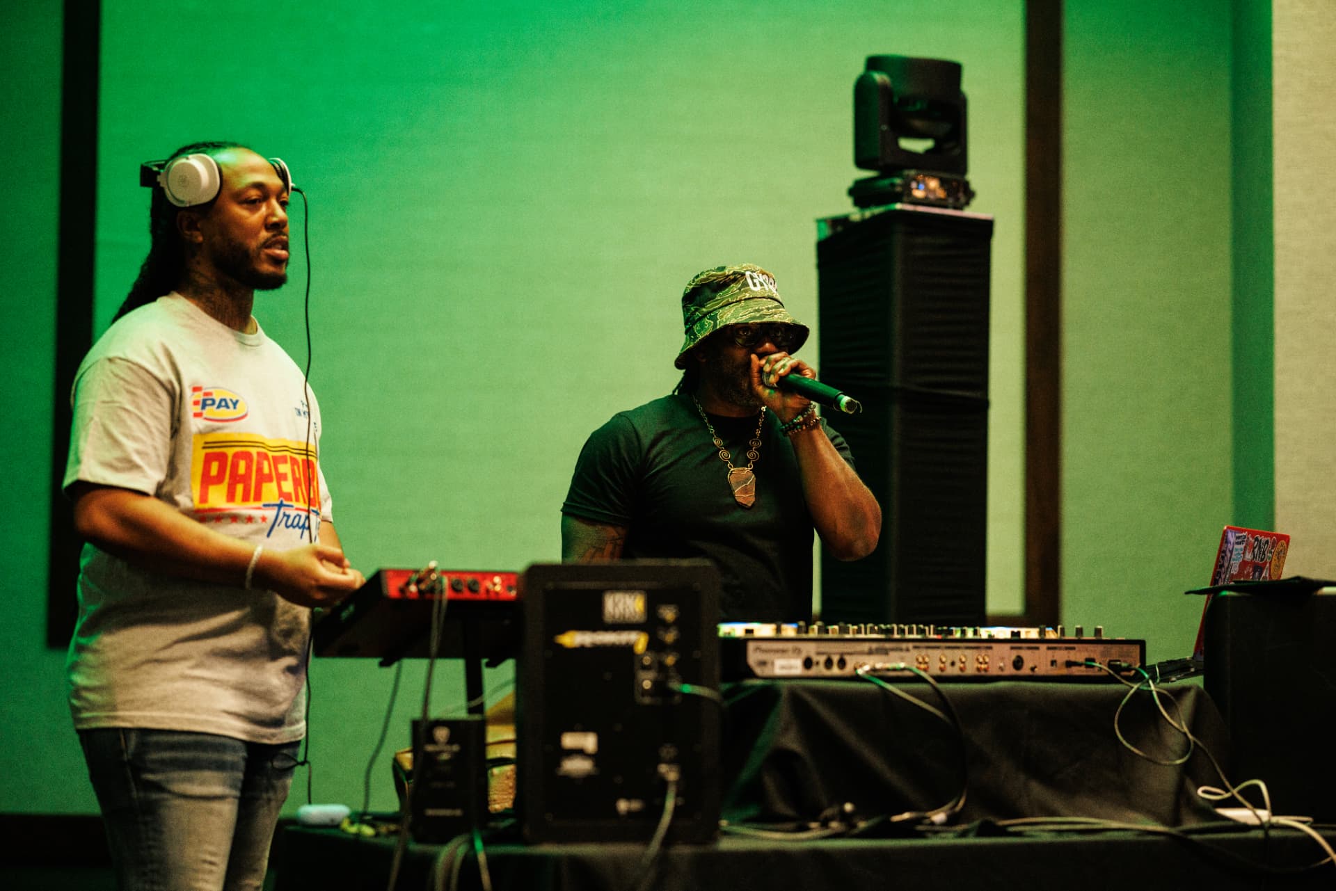 Facilitator on the microphone beside a DJ working the mixer